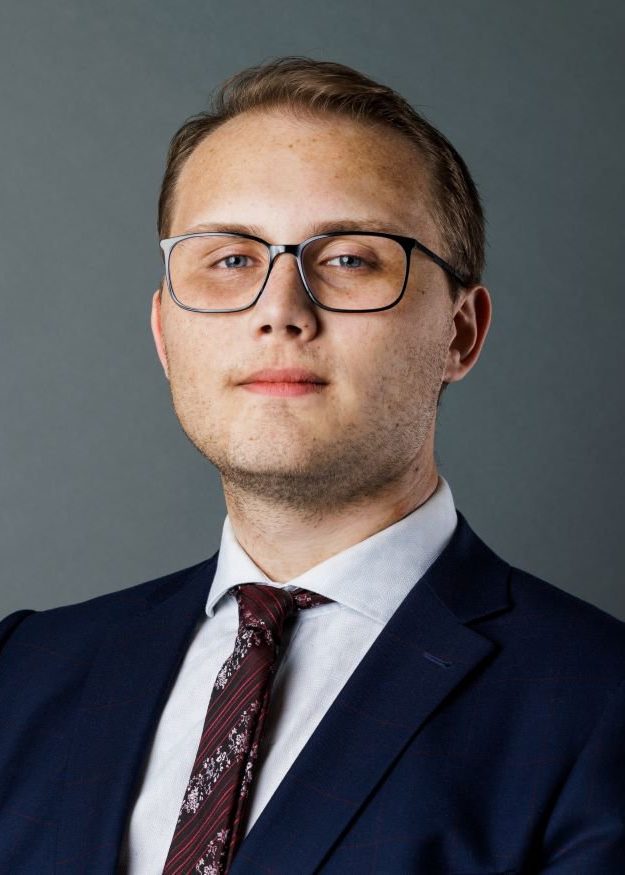 Jeremy Hoefsloot smiling and wearing a suit